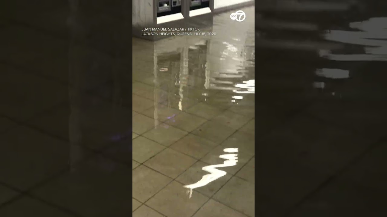 Driver wades through waist-high floodwater after vehicle gets stuck