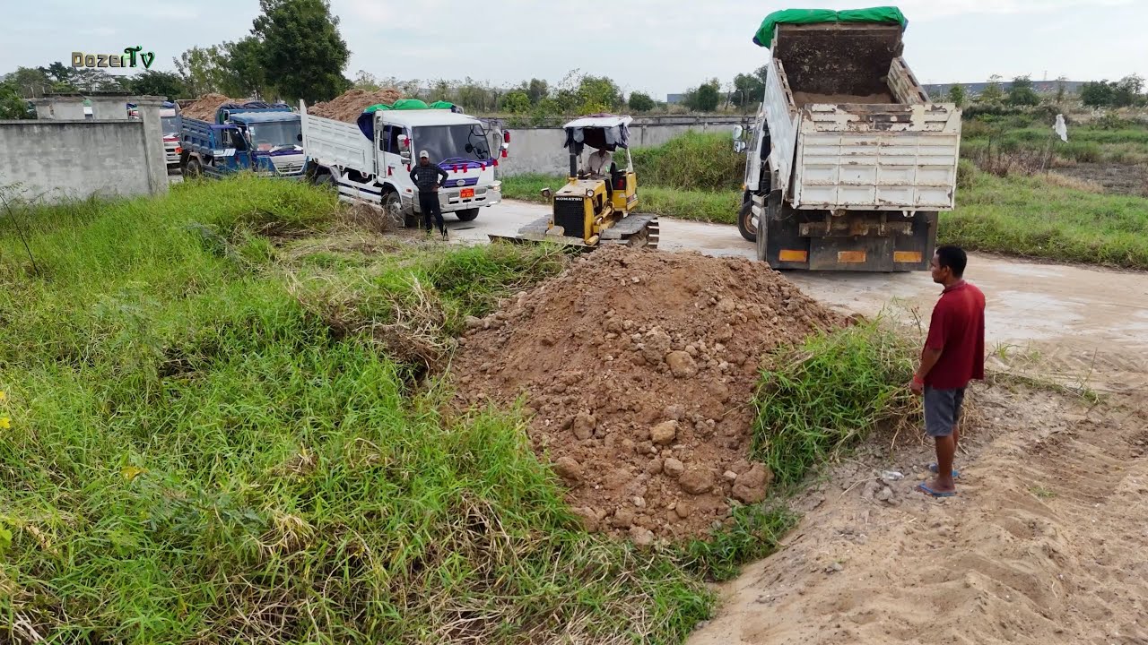 Land Filling Operation in Progress Perfect Teamwork Dozer & Dump Truck Drivers Moving Stone and Soil