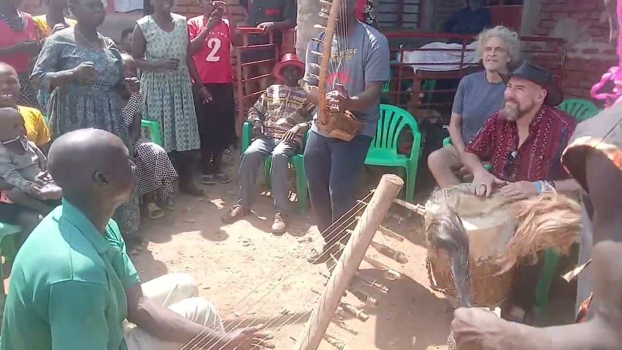 Kinobe plying adungu while David is drumming at Ngombor farm