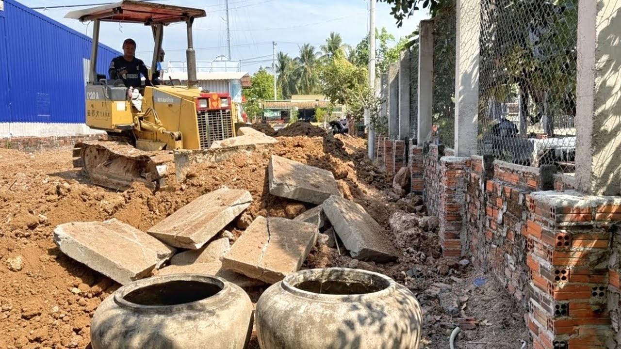 Clearing soil buries broken brick. In the yard around the house