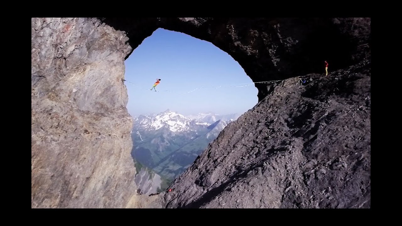 Professional Highliners set up a 25m long Highline through a famous hole in the Swiss Alps