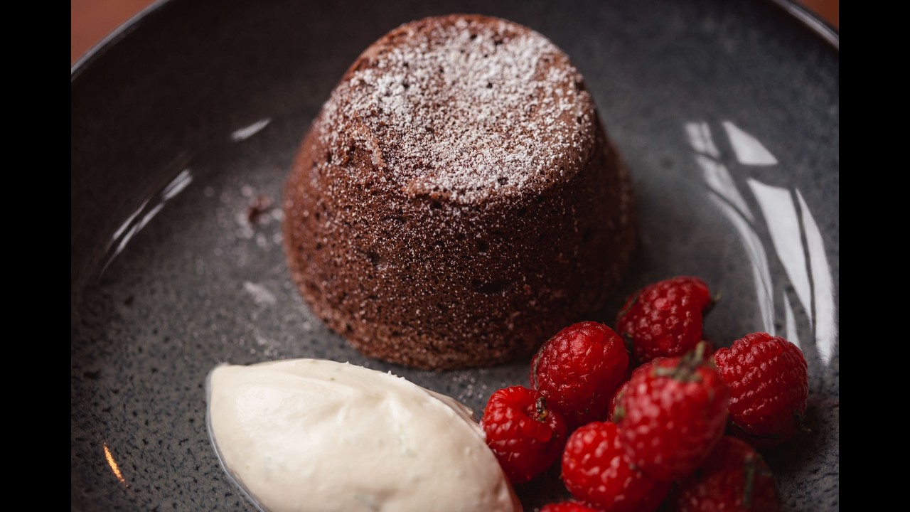 Chocolate fondant with lime crème and marinated raspberries