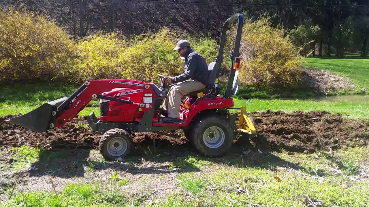 Massey GC1710 plowing a new garden spot with middle buster
