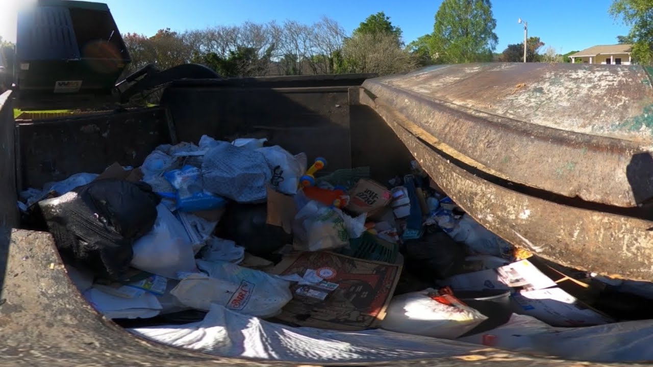 Front load garbage truck hopper cam
