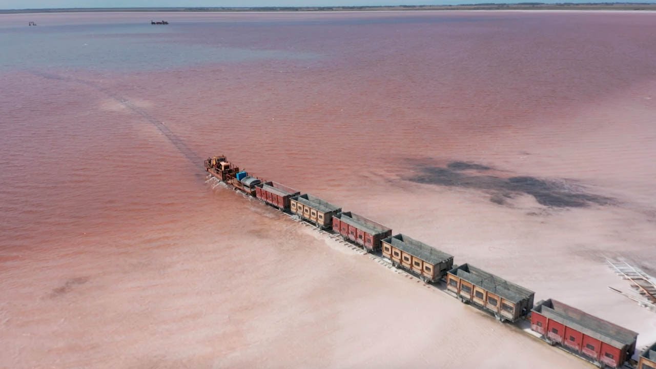 Train Travels Across Stunning Pink Salt Lake