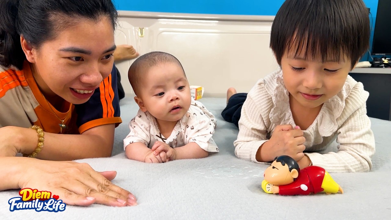Baby Kim looked so delighted and curious with her first toy
