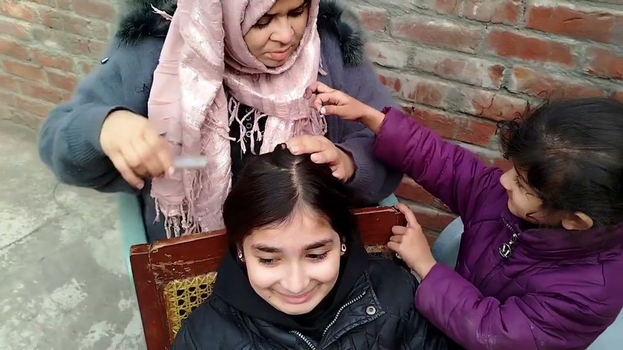 Mom did hair checking of my little sister.