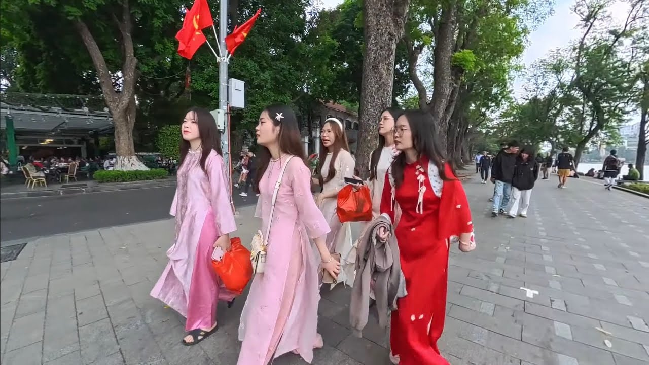 Hoan Kiem Lake, Hanoi, Vietnamese women look so beautiful in their ao dai dresses.