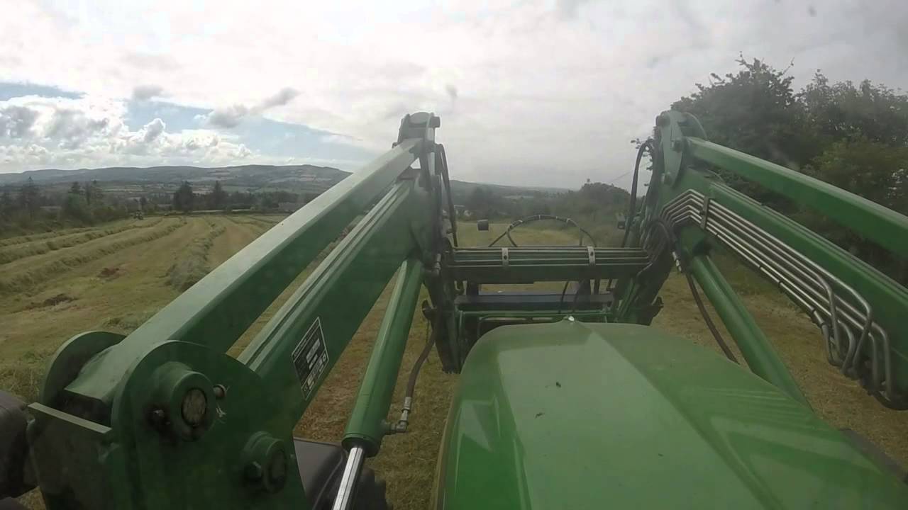 John Deere 6330  with 633 loader loading baled silage