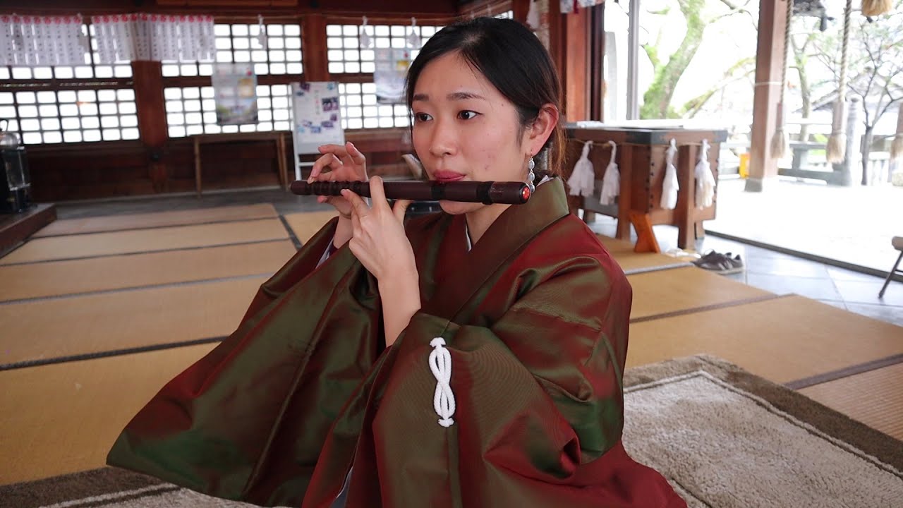 Playing the sacred instruments at Japanese shrine