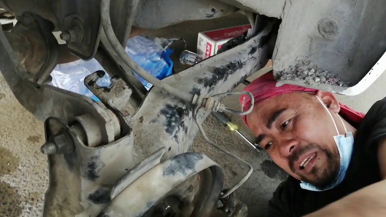 MITSUBISHI LANCER : REPLACE REAR SHOCK  LH & RH , REAR SUSPENSION BUSHINGS  AND OIL SEAL CRANK SHOP