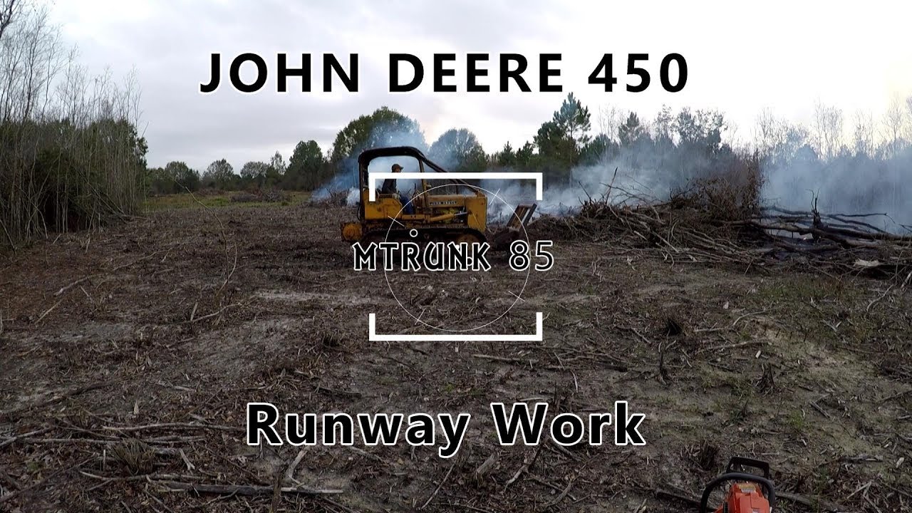 John Deere 450 Pushing Burning Debris Piles, Runway Project Continues