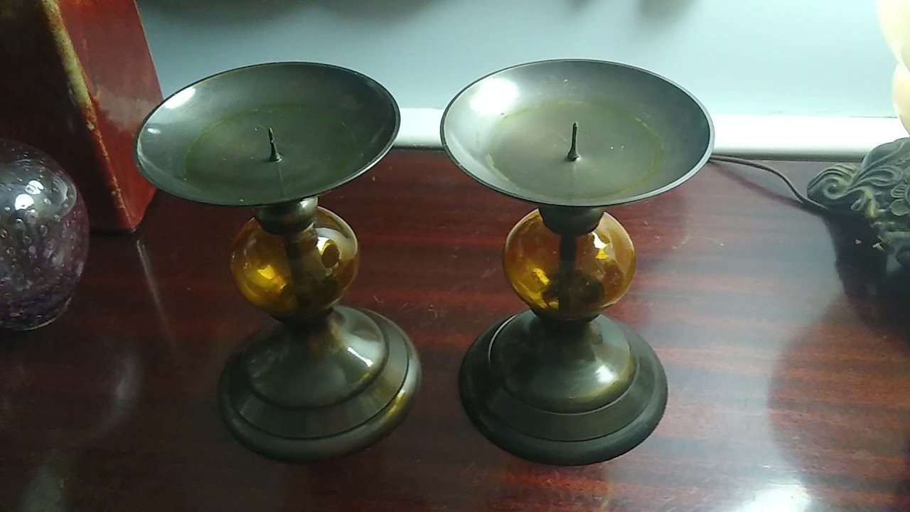 Two brass with amber glass large candle holders