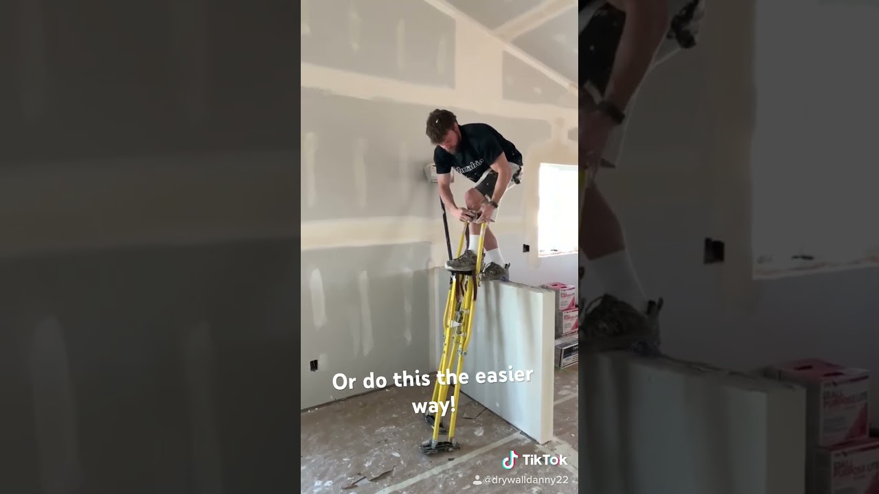 Putting on tall stilts using a ledge, much easier! #construction #drywall #drywalldanny #stilts