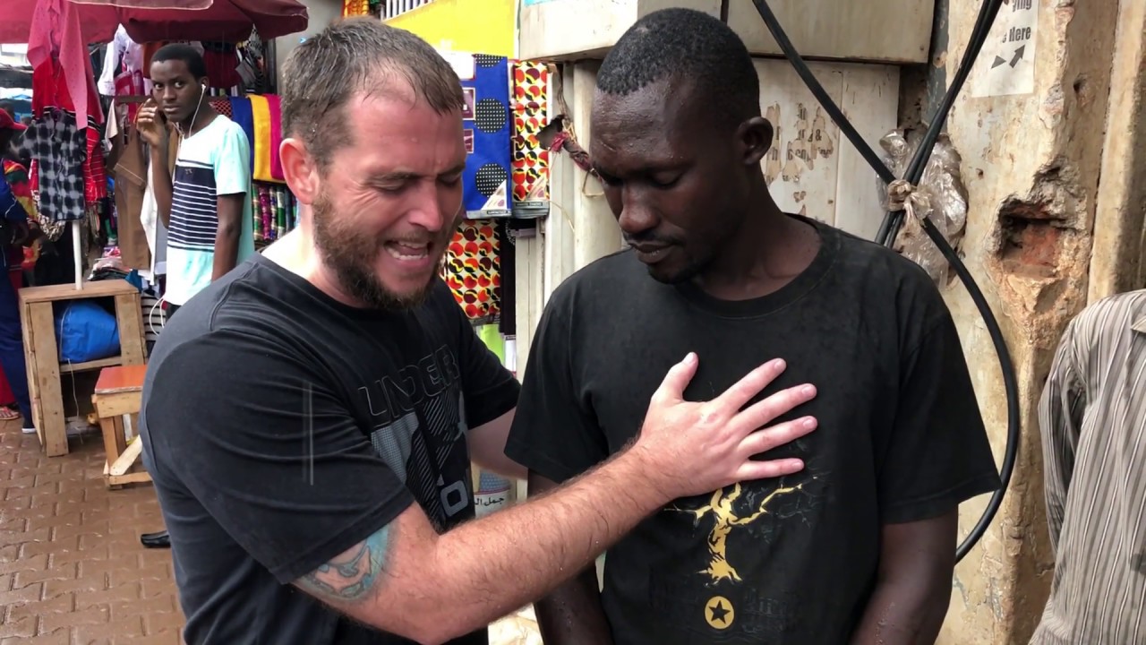 Preaching repentance in the rain in downtown Kampala, Uganda