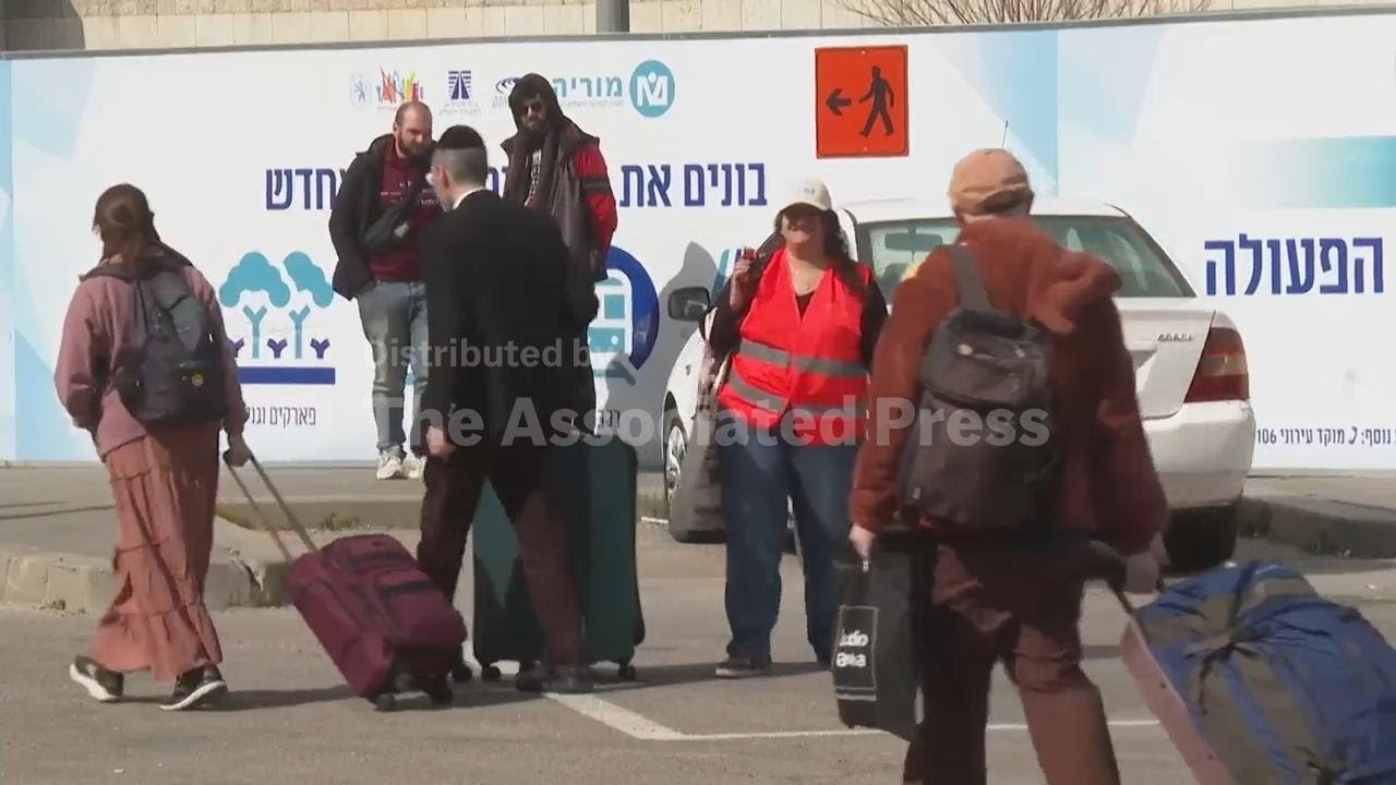 Tourists and foreign workers board buses in Jerusalem for Taba border crossing with Egypt