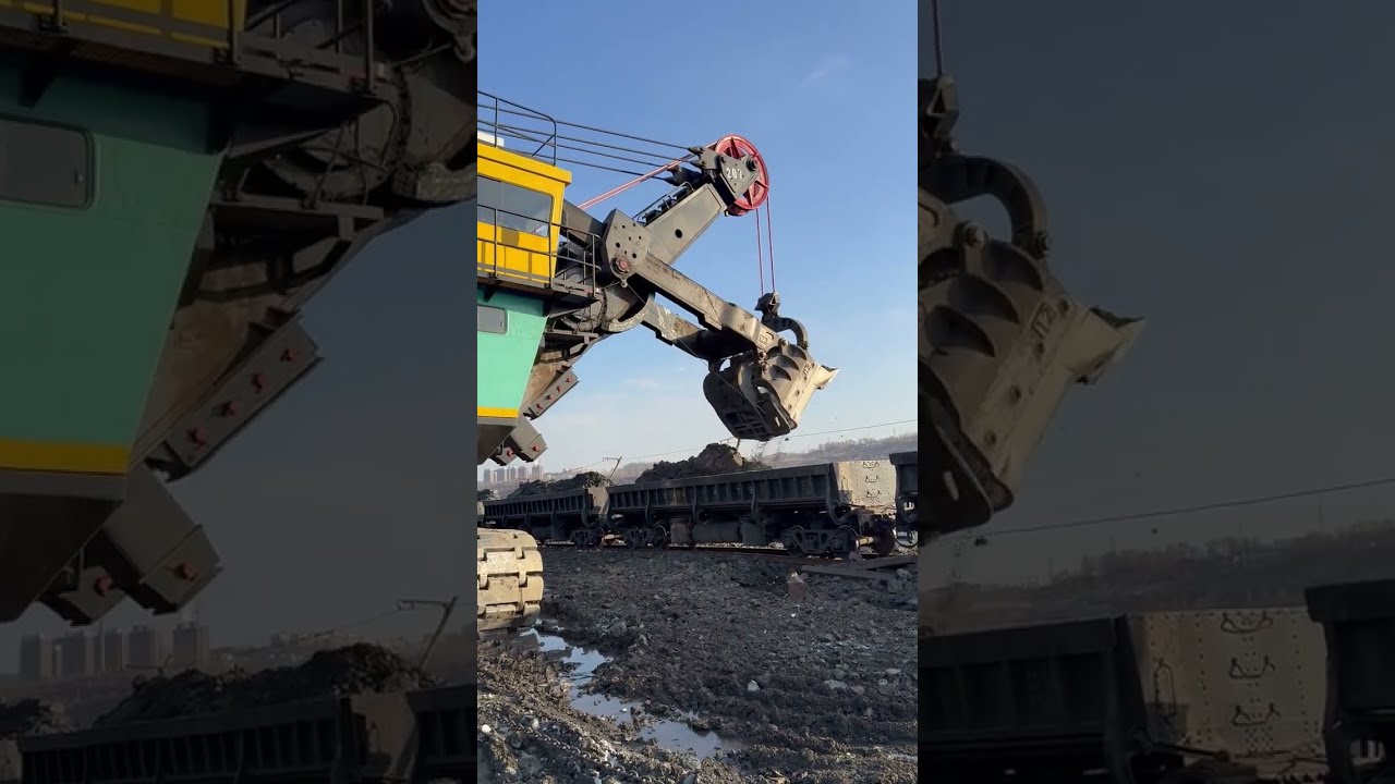 A large excavator with a 100 cubic meter bucket is mining ore 0202