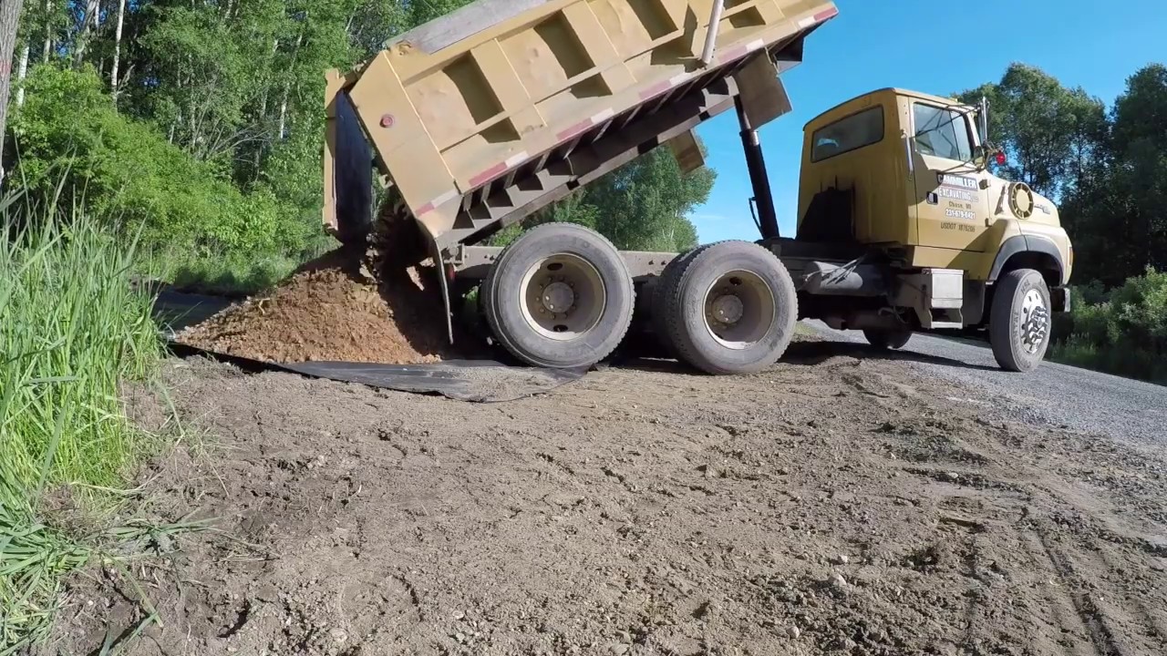 Putting a good driveway in a wet spot.