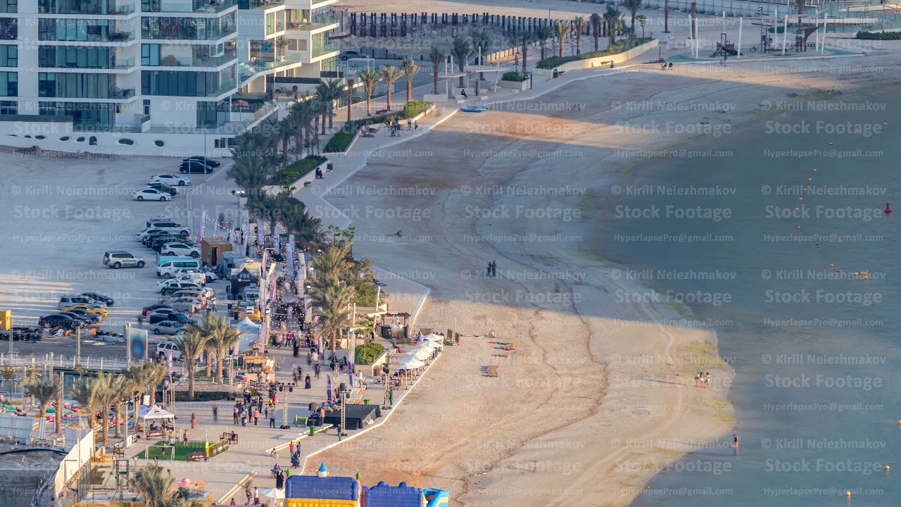 Beach on Al Reem island in Abu Dhabi during sunset timelapse from above.