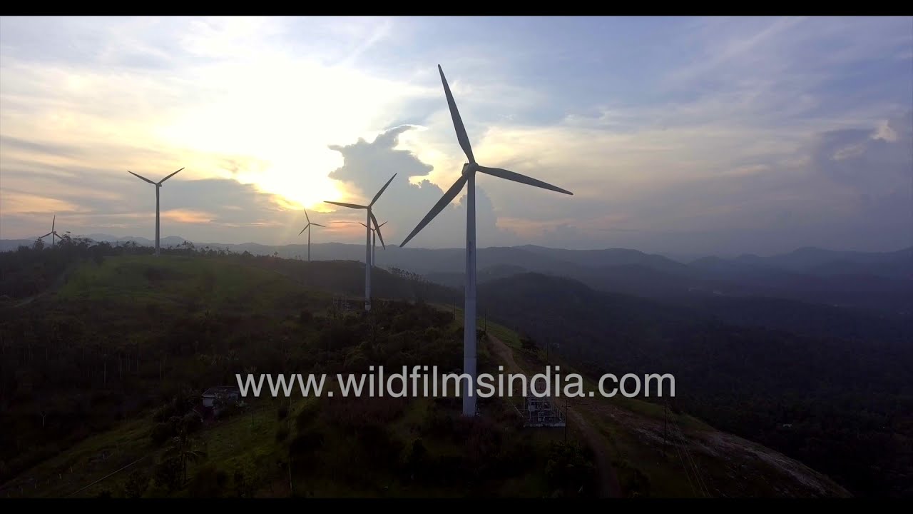 Ramakkalmedu Windmill Farm at sunset from sky | Windmill blades rotating seen in aerials