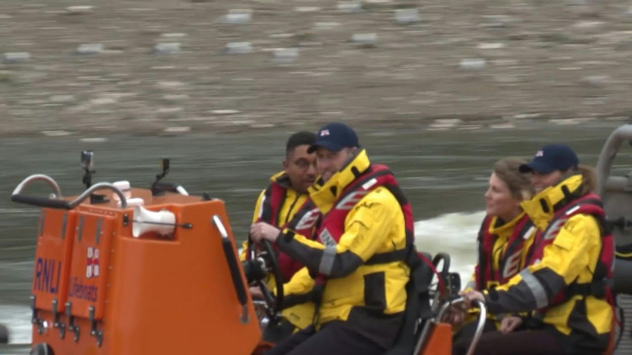 Prince William drives a lifeboat down the Thames | AFP