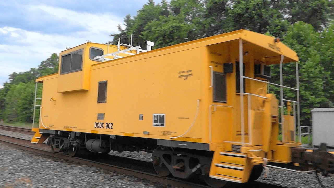 Yellow DODX Caboose On The Rear Of CSX Mixed Freight Train