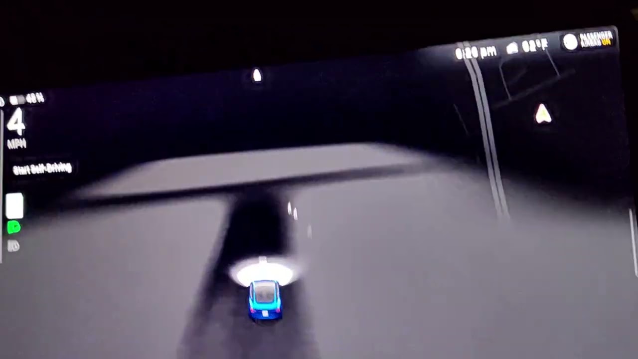 Tesla graveyard drive through at night.