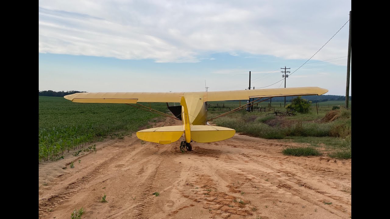 Partial engine power loss in a J4 ends in an off field landing.