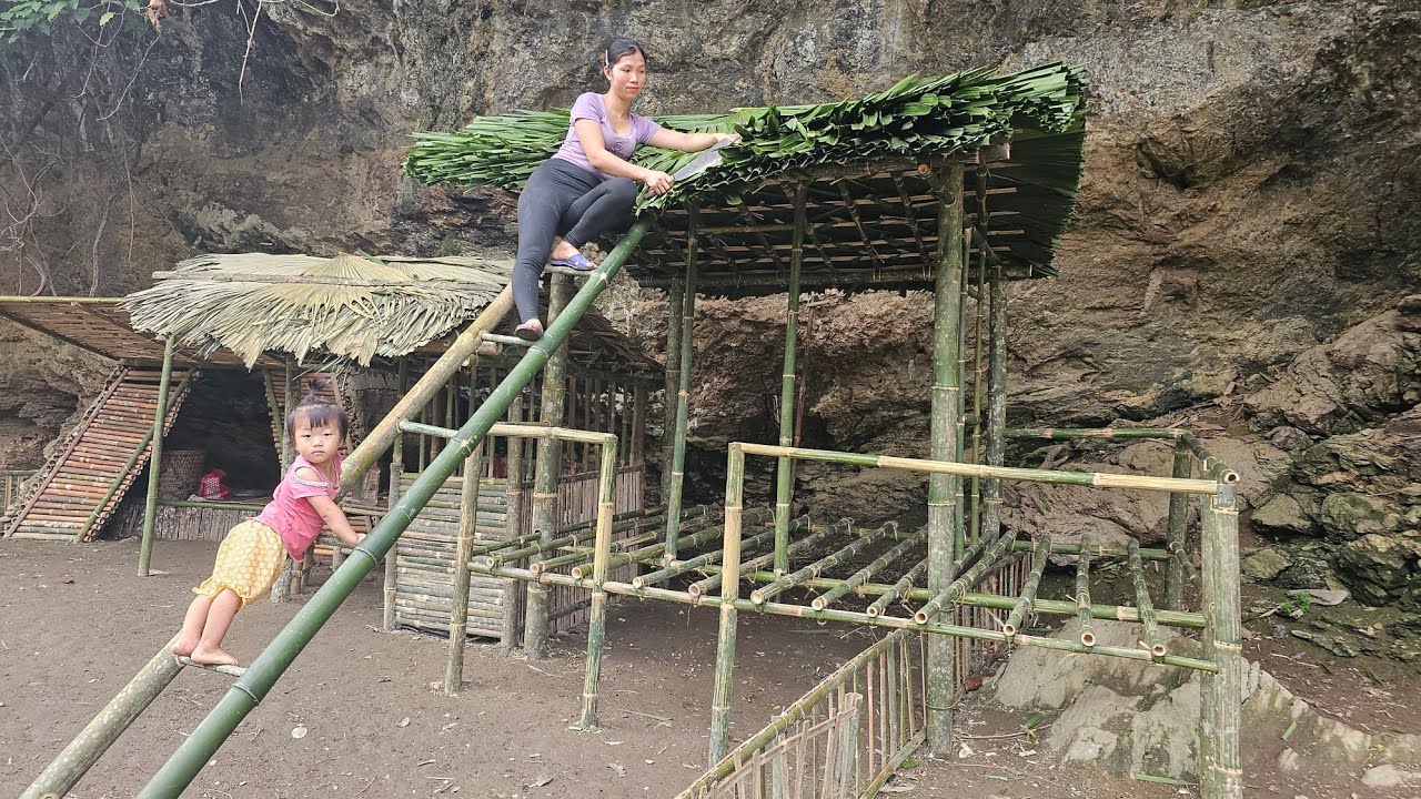 Girl building a thatched roof for a bamboo house - single mother