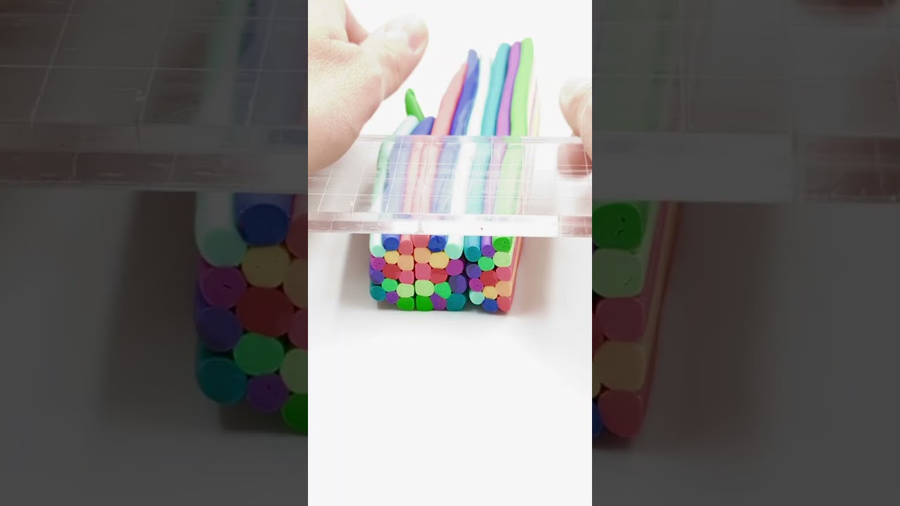 Artist is creating a vibrant colorful cane with polymer clay!
