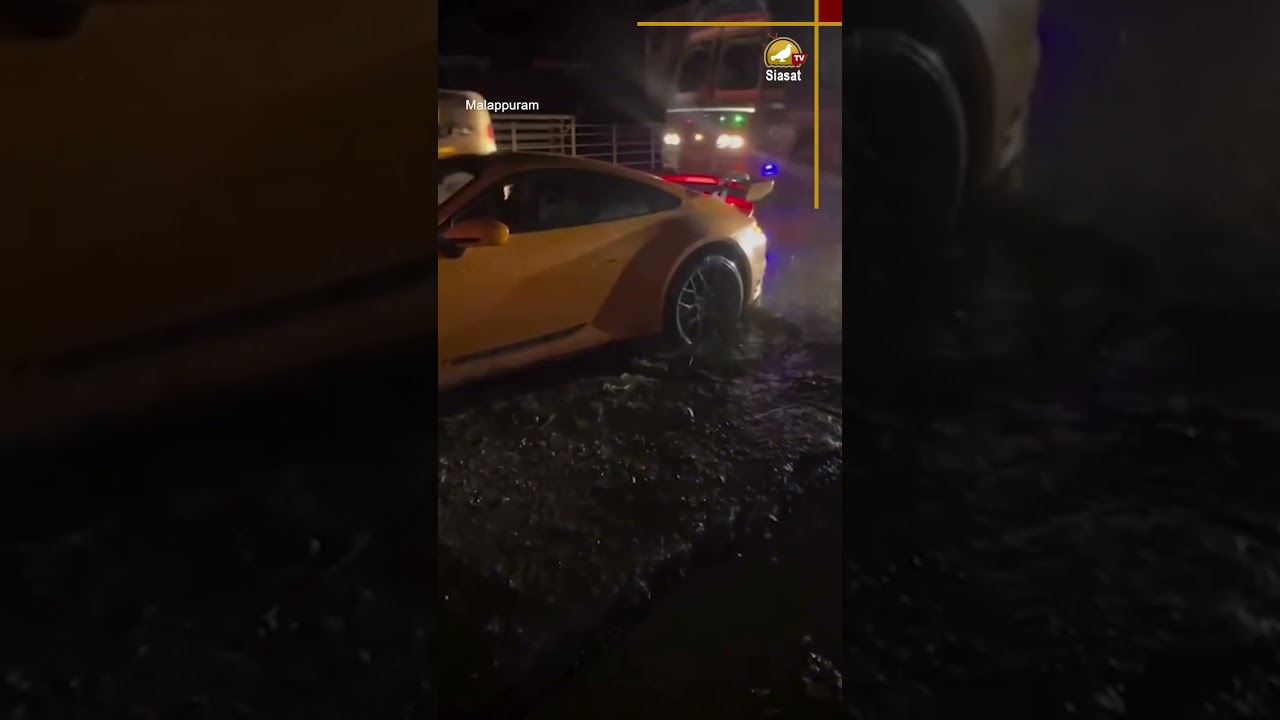 Porsche 911 Carrera got stuck in a deep, waterlogged pothole in Malappuram after heavy rains