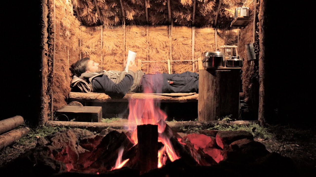 Outdoor Camping in a Bushcraft Shelter. Campfire cooking