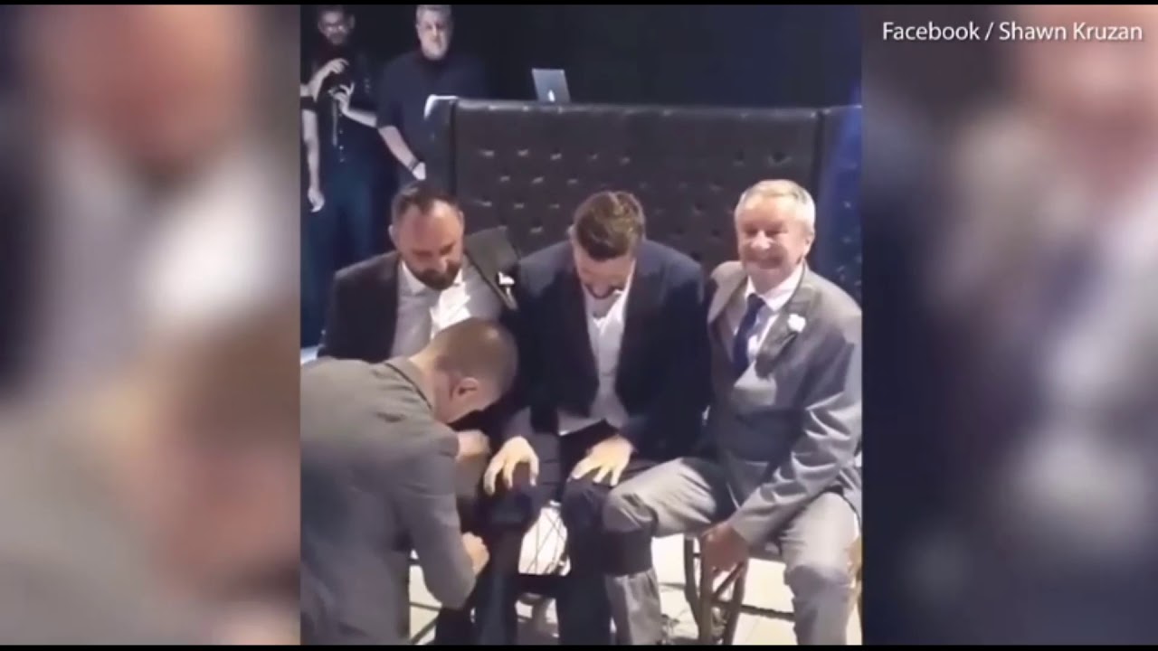 Tear-jerking moment wheelchair-bound groom lifted for first dance