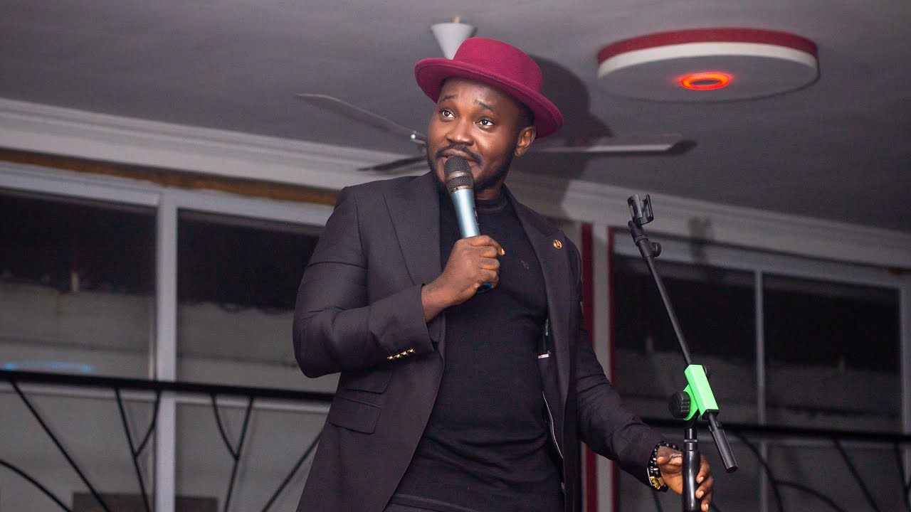OB Amponsah performs with a Sign language dude on stage.