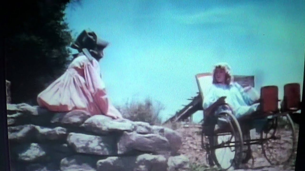 Laura Ingalls pushes Nellie Oleson down the hill