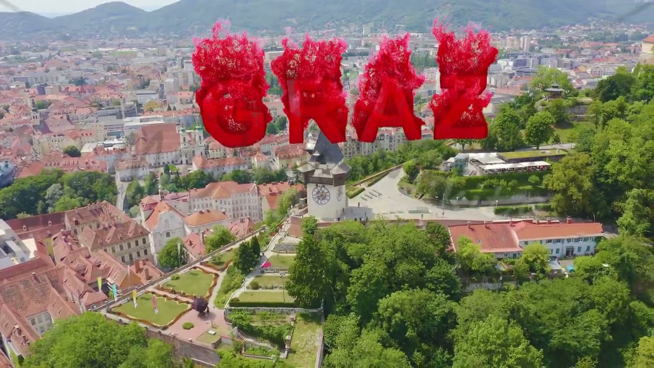 Inscription on video. Graz, Austria. Clock Tower in Graz. The historic city center aerial view. Moun