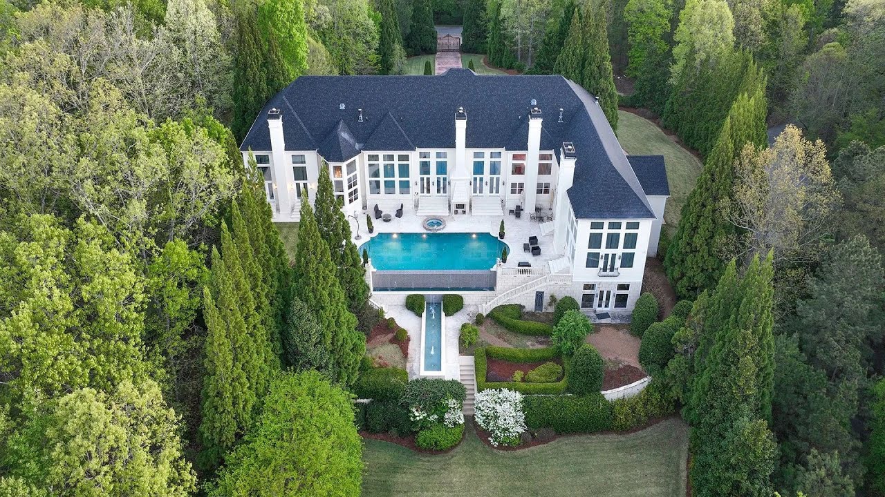 $5.25M Grand chateau in Fairburn offers over 16,000 SF of living space with a lighted tennis court