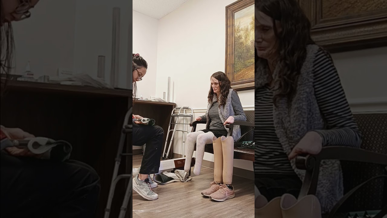Quadruple amputee demonstrates how to put on leg prosethic