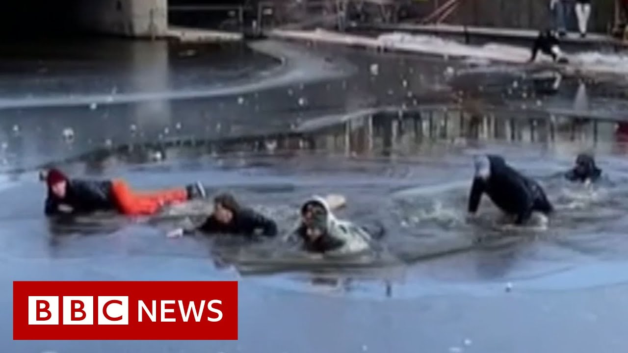 Group of skaters rescued after falling through ice - BBC News