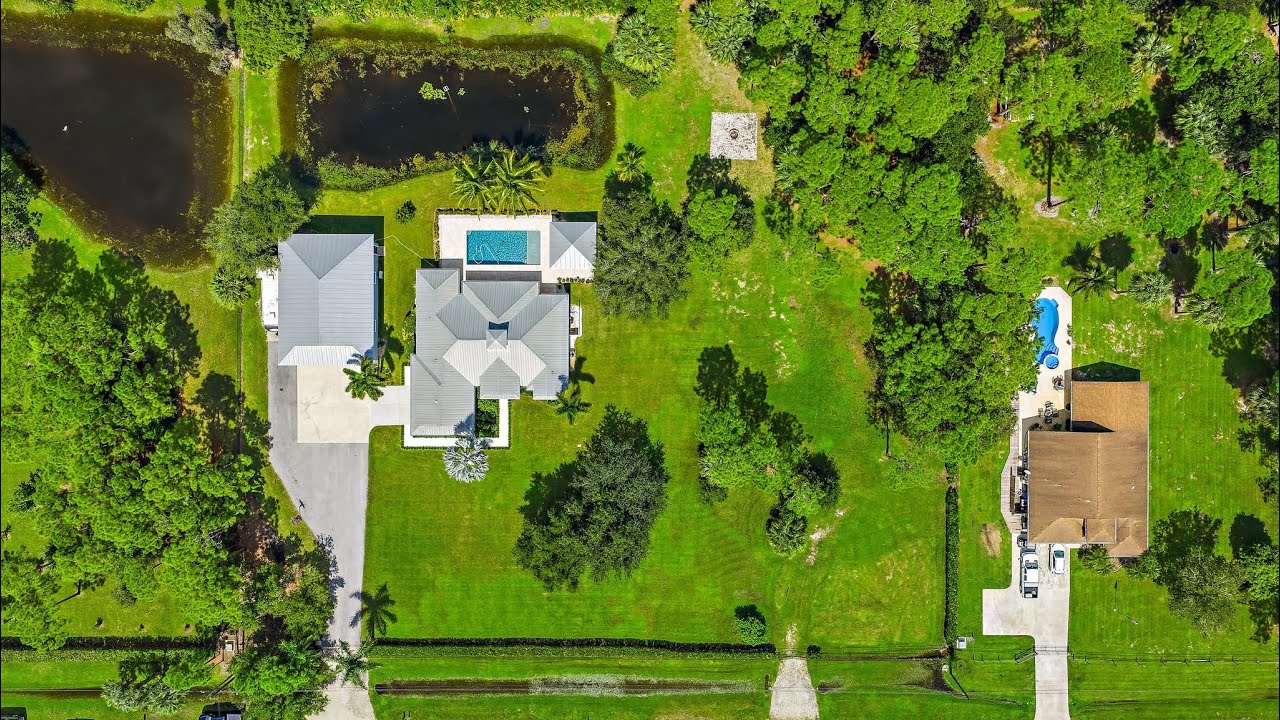 Jupiter Farms Luxury Redefined 2.4 Acres of Elegance | 1,750 SqFt Dream Garage| Resort Style Living.