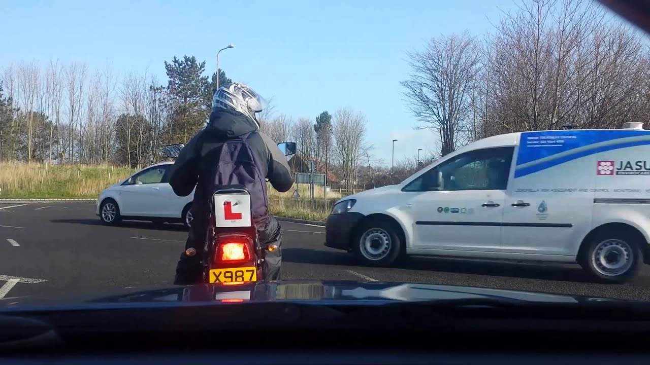 Taxi cuts up moped on roundabout