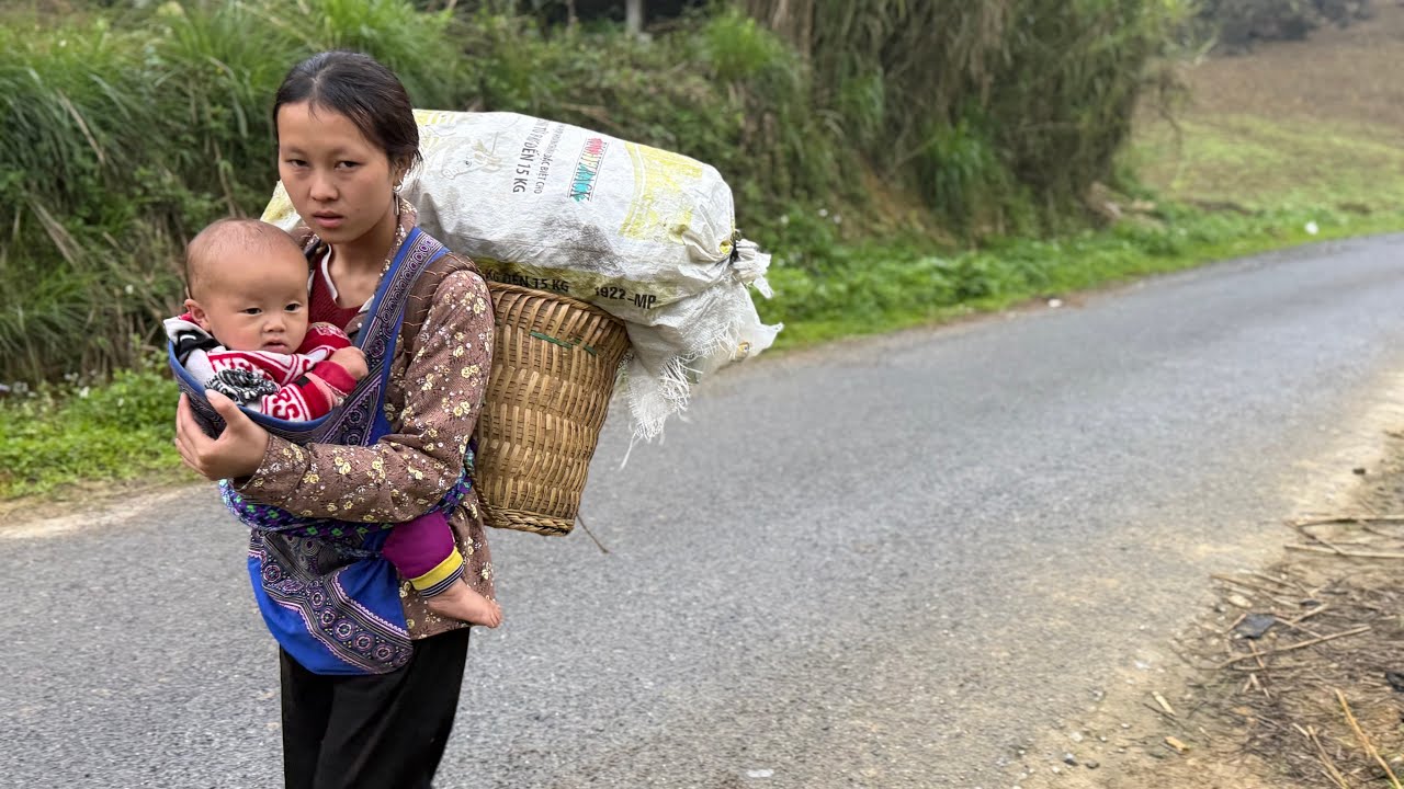 Carrying her young child and a load of recyclable materials on her back, this single mother is..