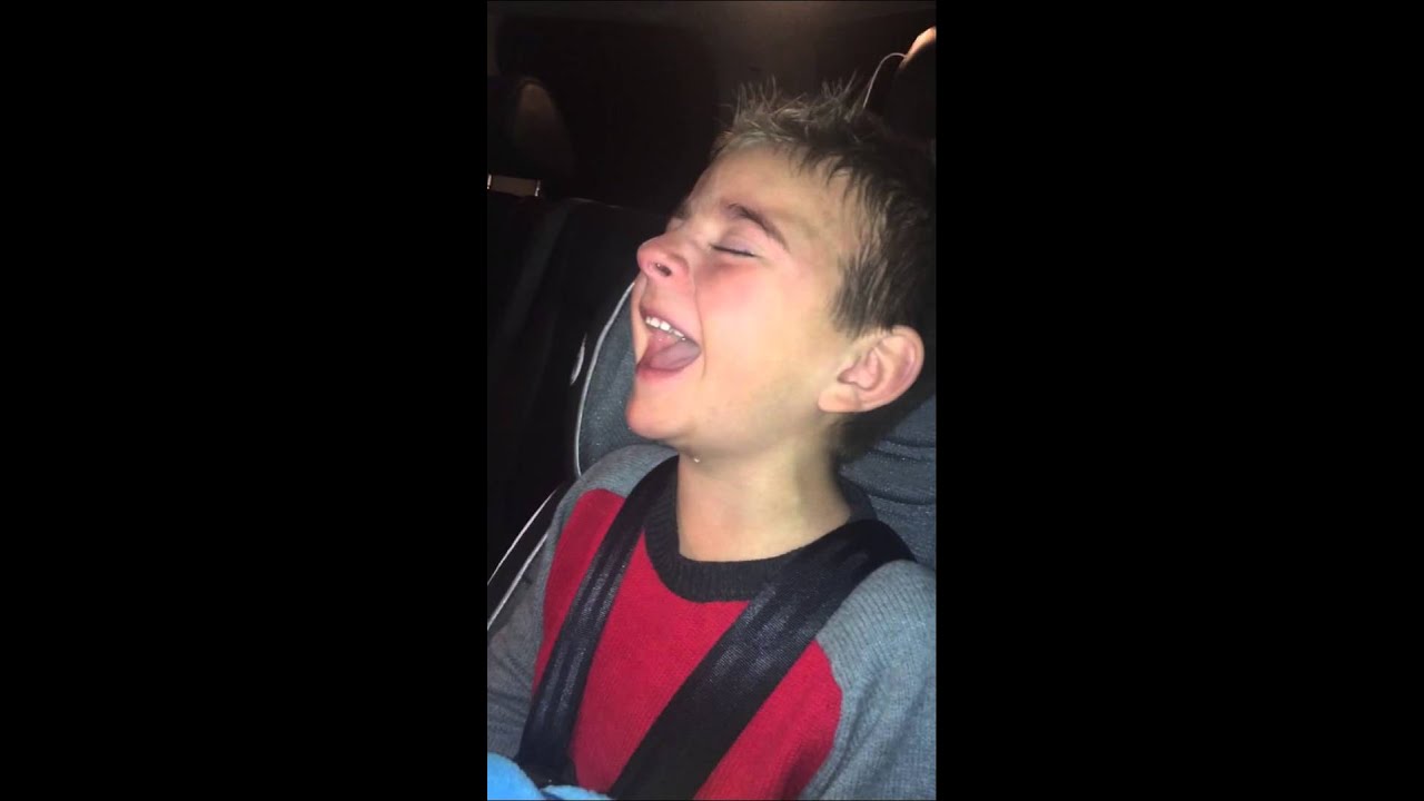 boy hysterically laughing in his sleep