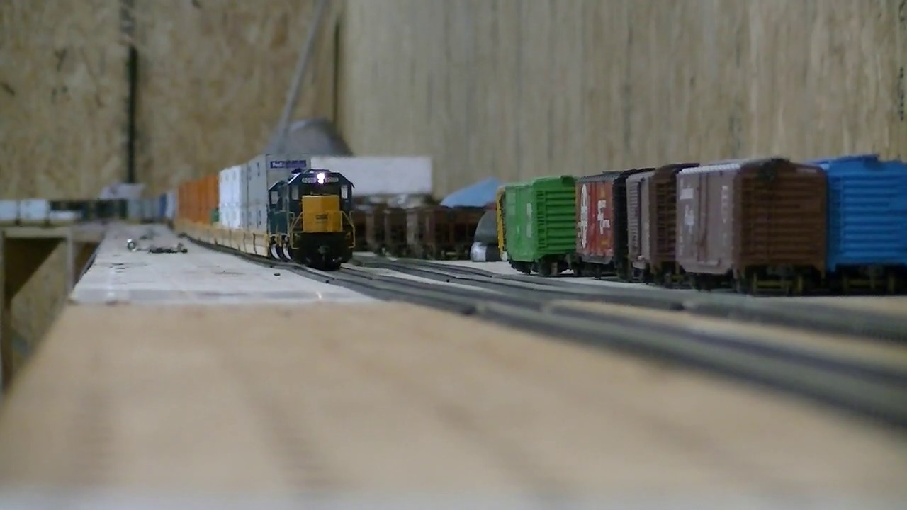 Two HO scale SD40-2 athearns pull long intermodal train