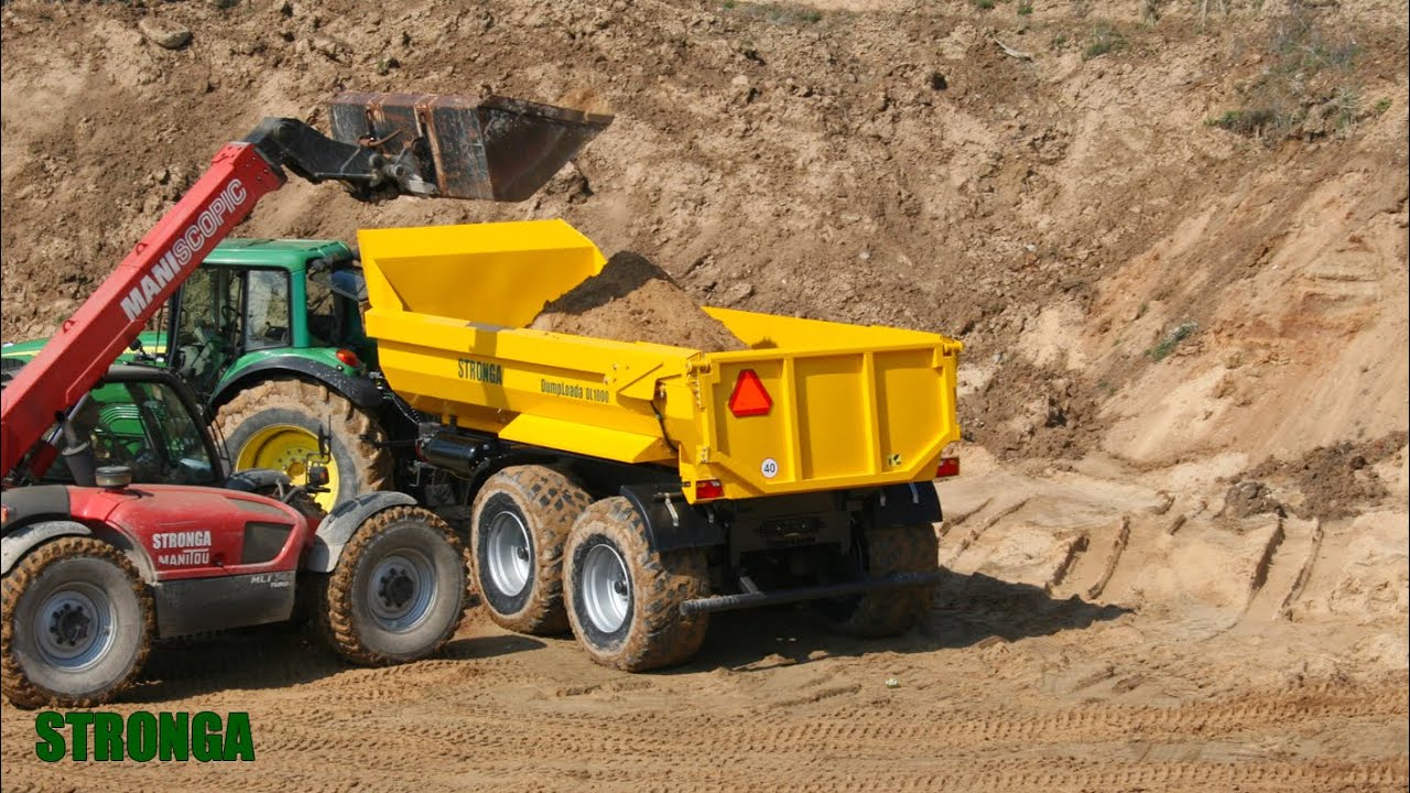 Stronga DumpLoada DL1000HP med en John Deere traktor Transport tung av sand