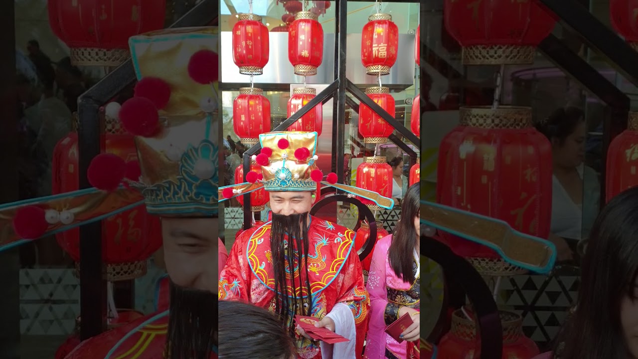 Chinese God of Fortune handing out fortune cookies at Skycity Auckland 2021 New Year Celebrations.