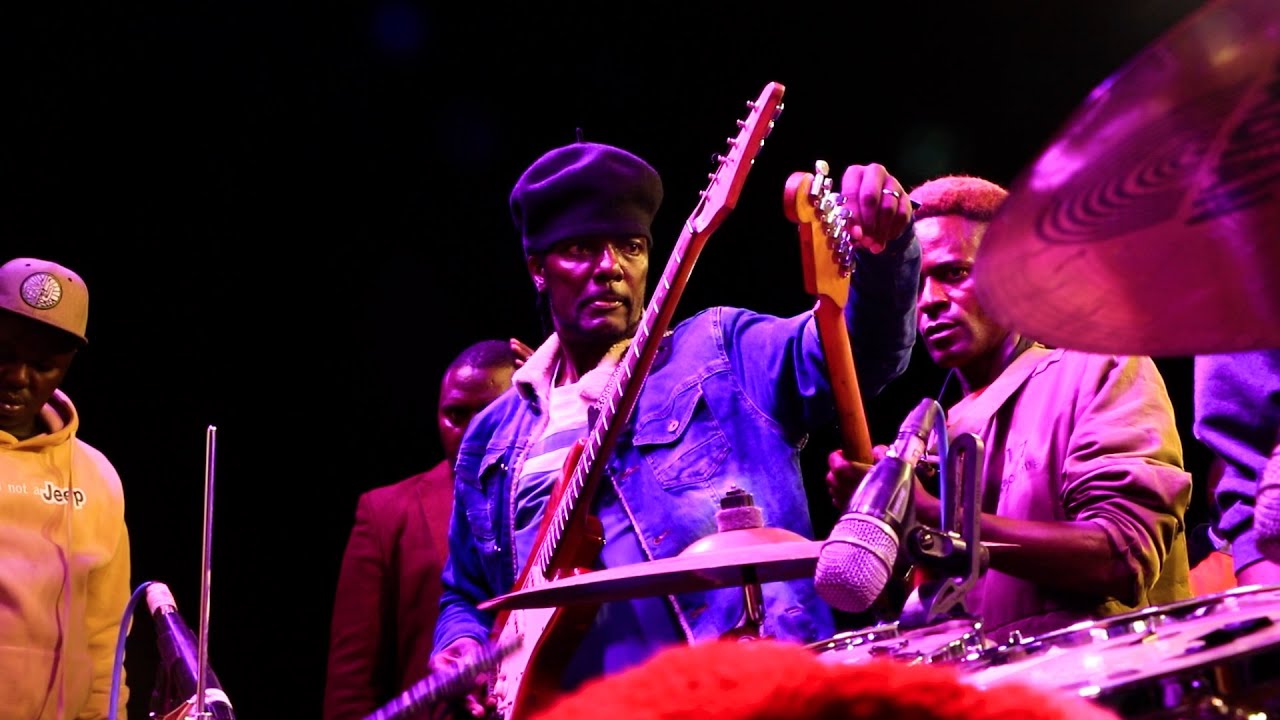 Kativui Mweene tuning guitar at Lysak During Mbaitu Night