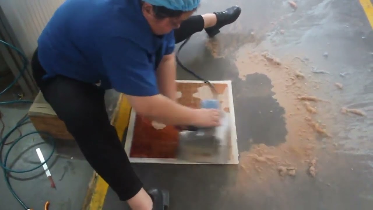 The process of making an Axminster carpet sample.