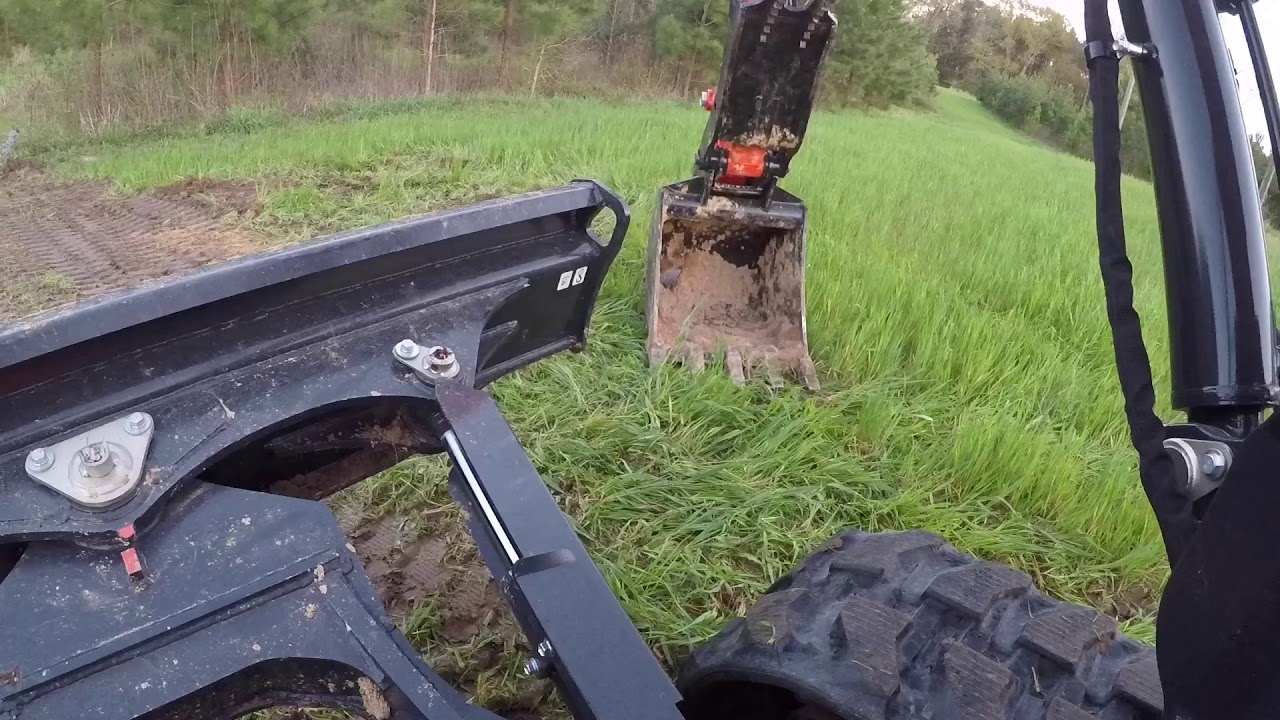 Kubota KX057-4 digging dirt & logging