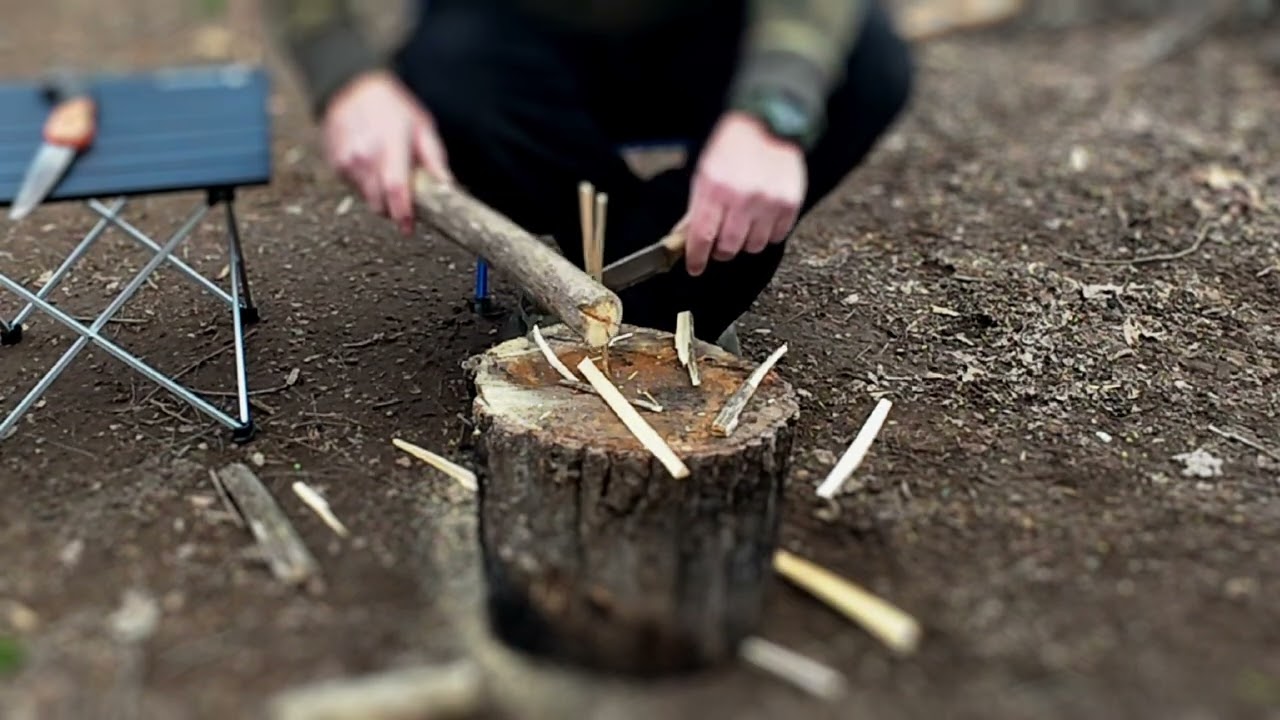 Batoning fire wood and processing kindling to make fire starting easier.